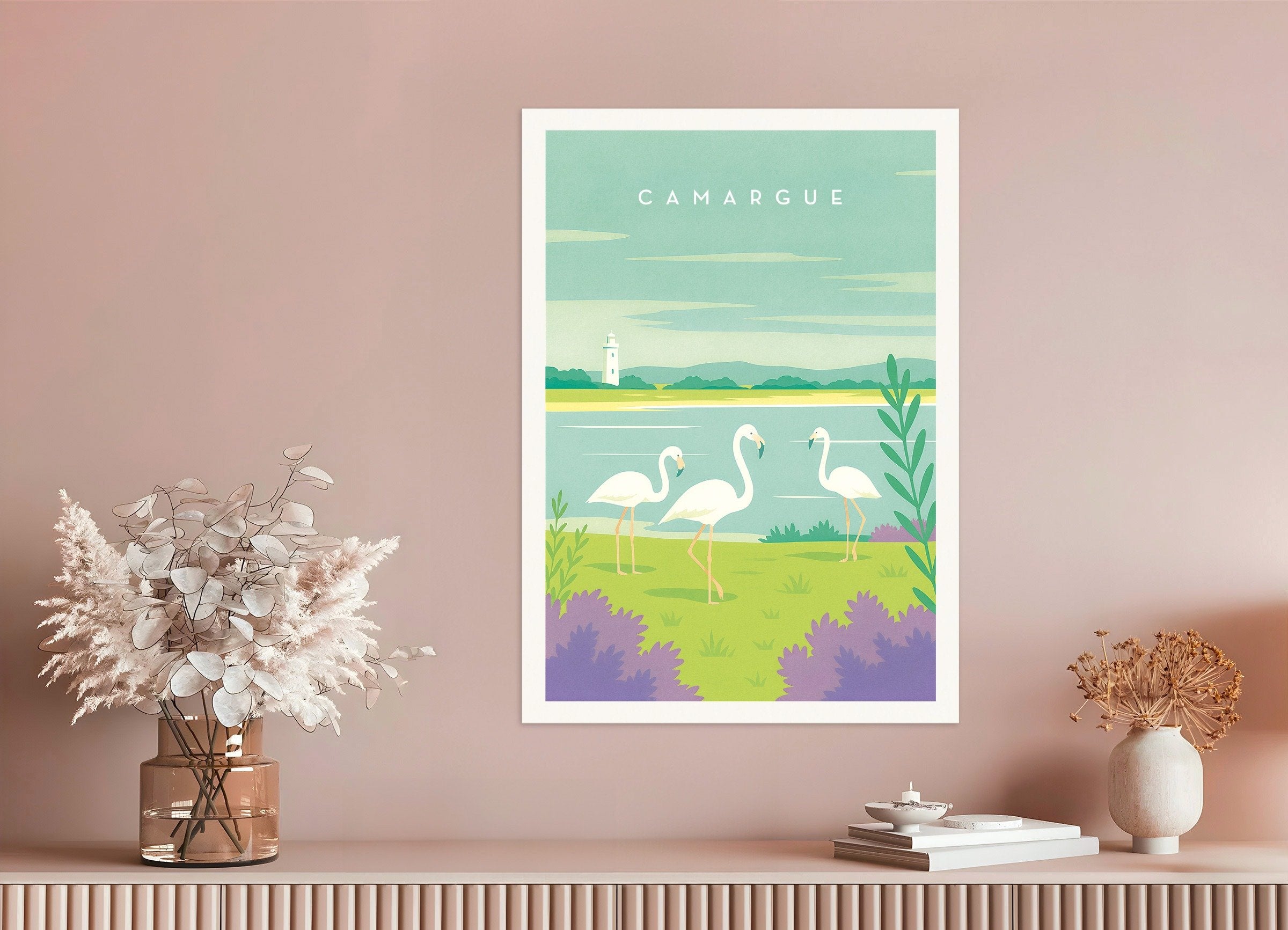 Framed artwork of flamingos in a natural setting on a pink wall.